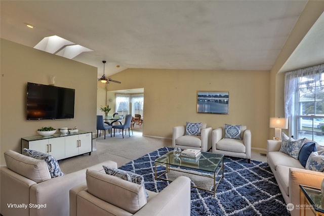 living room with lofted ceiling, carpet flooring, and ceiling fan