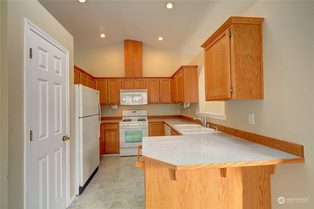 kitchen with sink, white appliances, a breakfast bar, vaulted ceiling, and kitchen peninsula