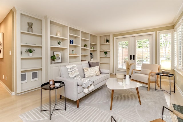 living area with light hardwood / wood-style floors and french doors