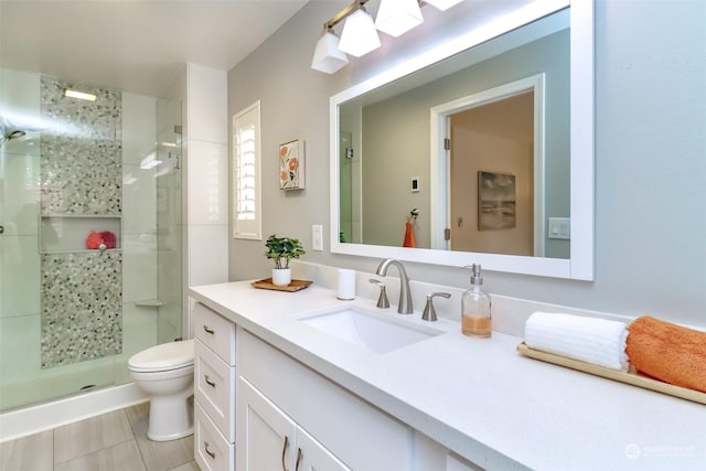 bathroom featuring walk in shower, vanity, and toilet