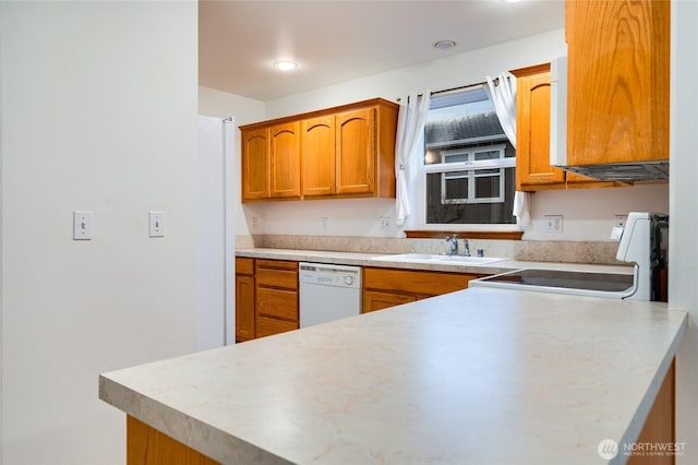 kitchen featuring brown cabinetry, white appliances, and light countertops