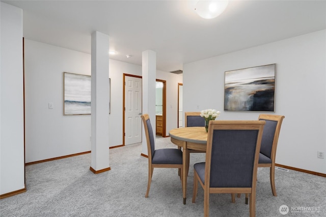 carpeted dining area with visible vents and baseboards