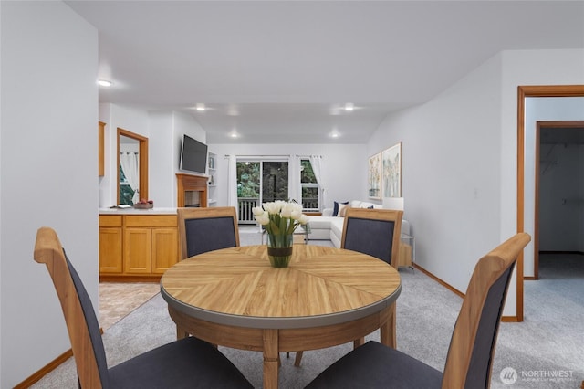 dining space featuring light carpet, baseboards, and recessed lighting