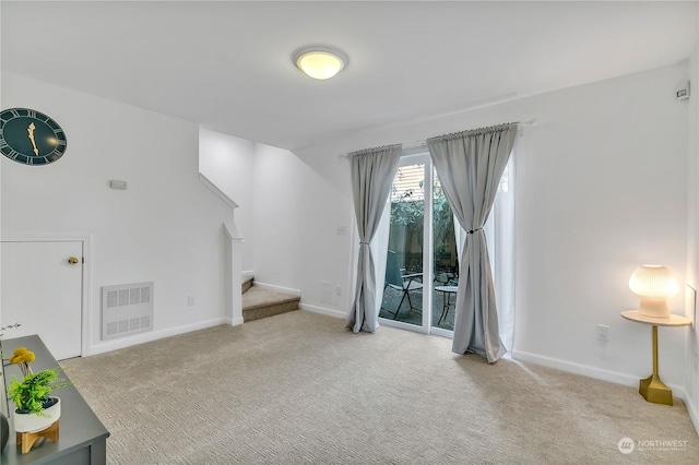 living room with stairs, carpet flooring, visible vents, and baseboards