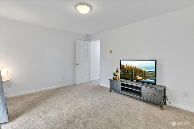 carpeted living area with baseboards