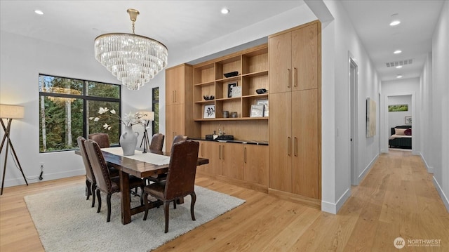 dining area featuring a chandelier and light hardwood / wood-style floors