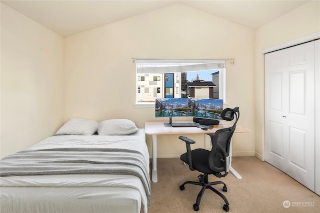 bedroom featuring a closet, vaulted ceiling, and light carpet