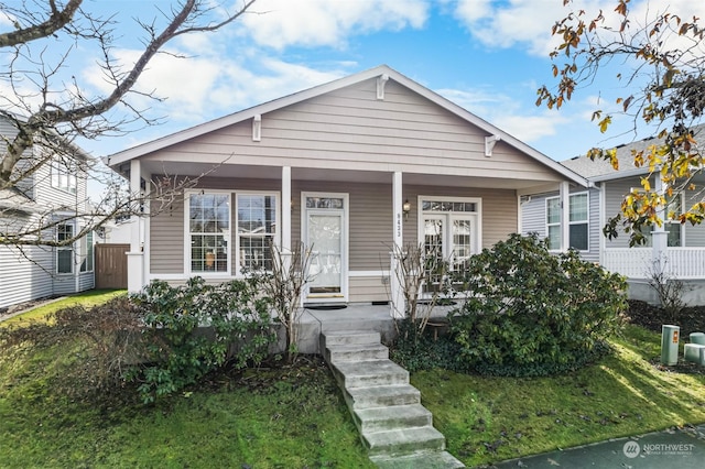 bungalow-style house with a front lawn and a porch