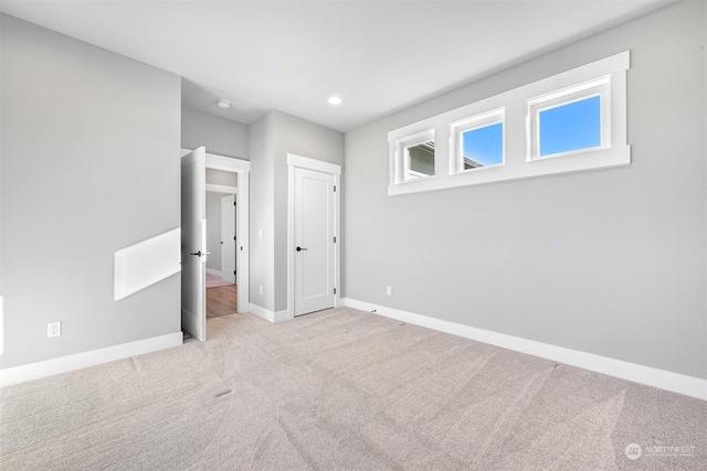 unfurnished bedroom featuring light carpet