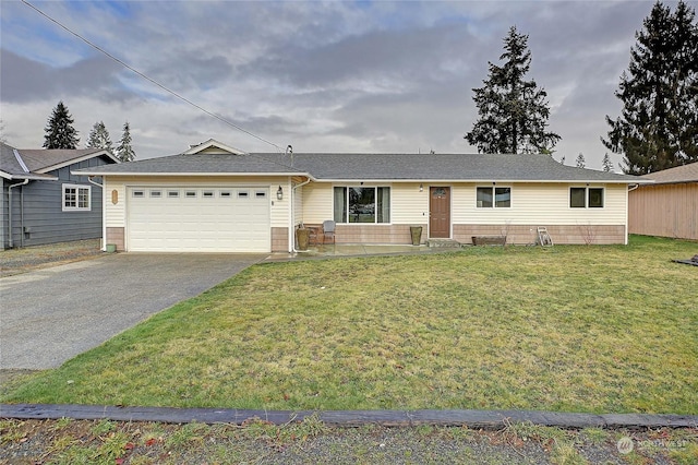 ranch-style house with a garage and a front yard