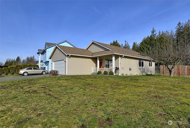 view of front of home with a porch, a garage, and a front lawn