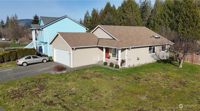 view of front facade featuring a garage, a front yard, and covered porch