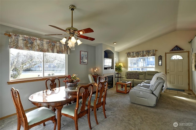 dining room featuring vaulted ceiling, carpet, and ceiling fan