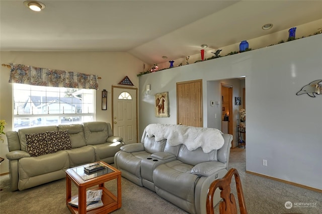 carpeted living room featuring vaulted ceiling