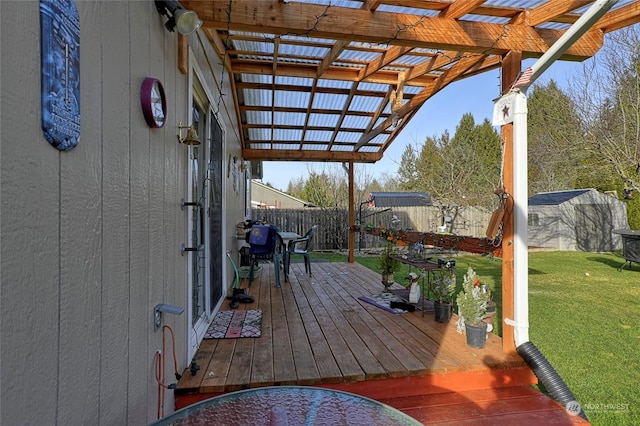 wooden deck with a yard and a pergola