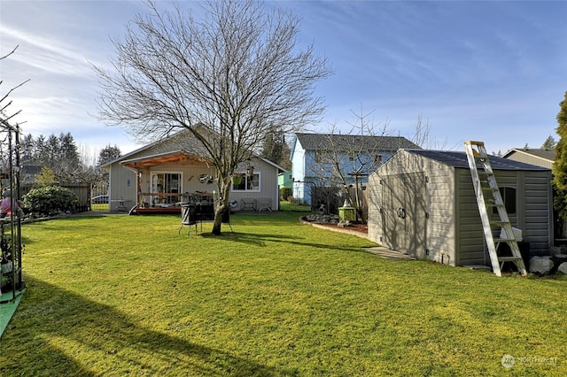 rear view of property with a yard and a shed