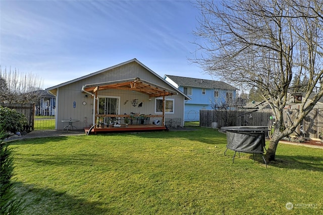 rear view of property with a yard and a deck