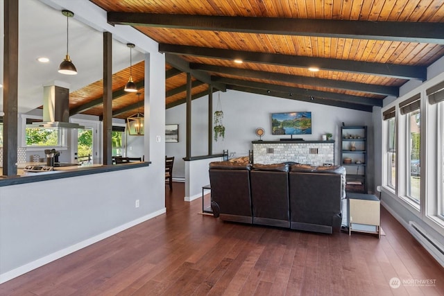 unfurnished living room with a baseboard heating unit, dark wood-type flooring, lofted ceiling with beams, and a wealth of natural light