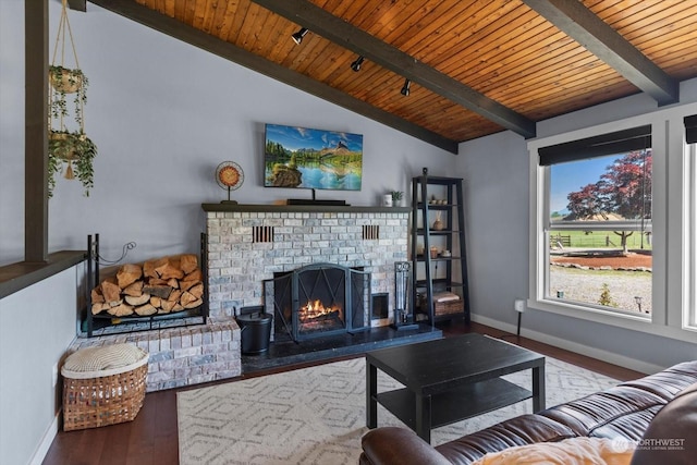 living room featuring wood ceiling, a fireplace, lofted ceiling with beams, and wood finished floors