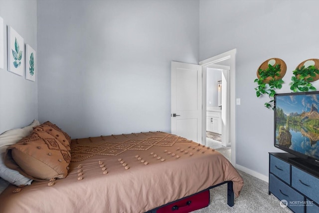 bedroom featuring light carpet and baseboards