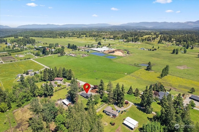 birds eye view of property featuring a mountain view and a rural view