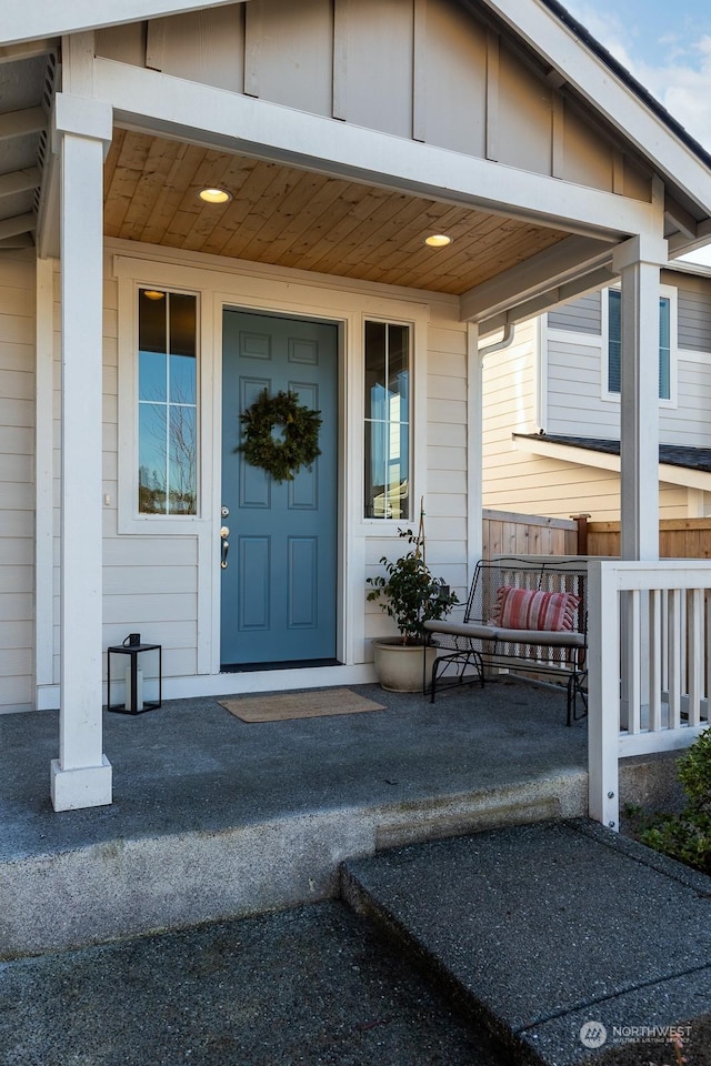 view of exterior entry with a porch