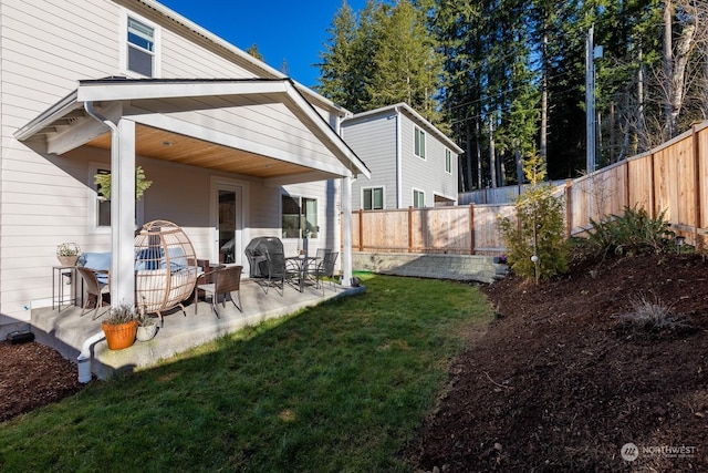 rear view of property featuring a yard and a patio area