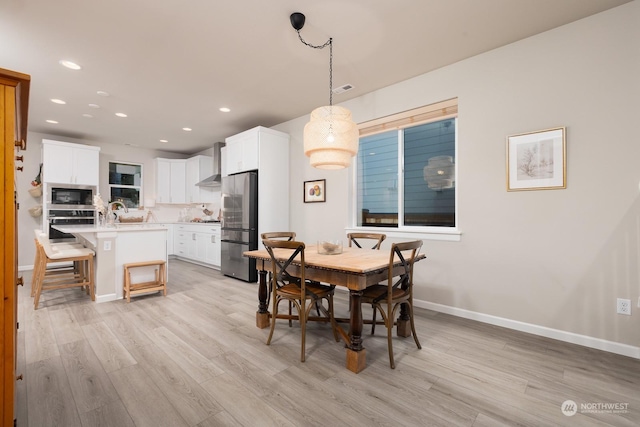 dining room with sink and light hardwood / wood-style floors