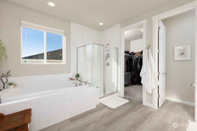 bathroom featuring hardwood / wood-style flooring and shower with separate bathtub