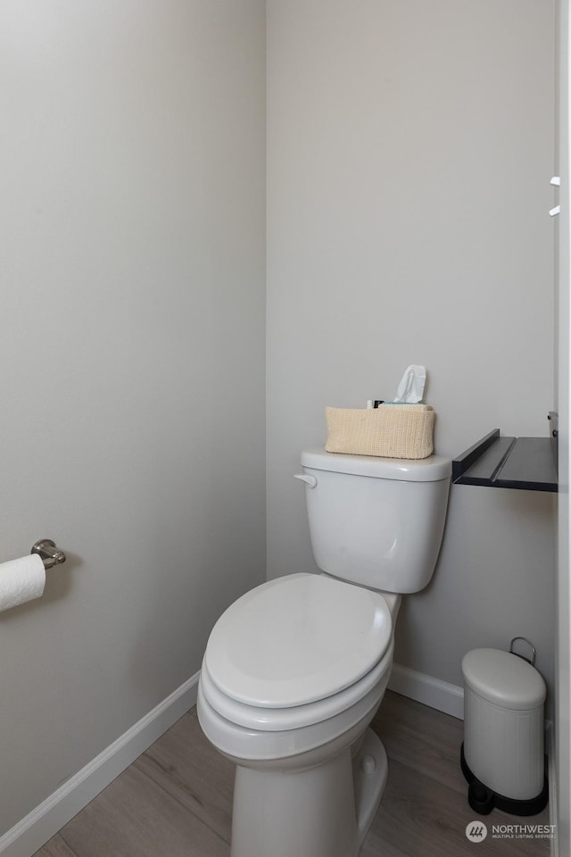 bathroom with toilet and hardwood / wood-style floors