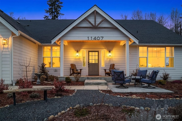 exterior space featuring a shingled roof