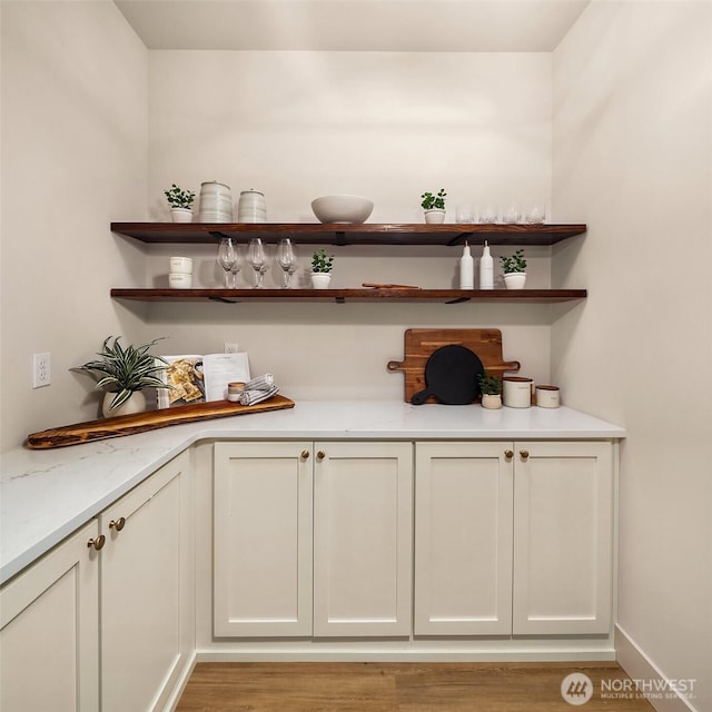 bar with light wood-style flooring