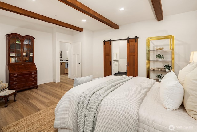 bedroom with a barn door, baseboards, light wood-style flooring, beamed ceiling, and recessed lighting