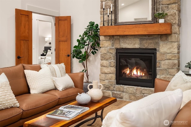 living room with a fireplace and wood finished floors