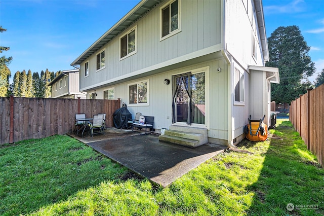 back of house featuring a yard and a patio area