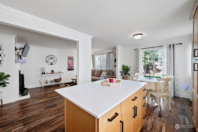 kitchen featuring a kitchen island, dark hardwood / wood-style floors, a fireplace, and a textured ceiling