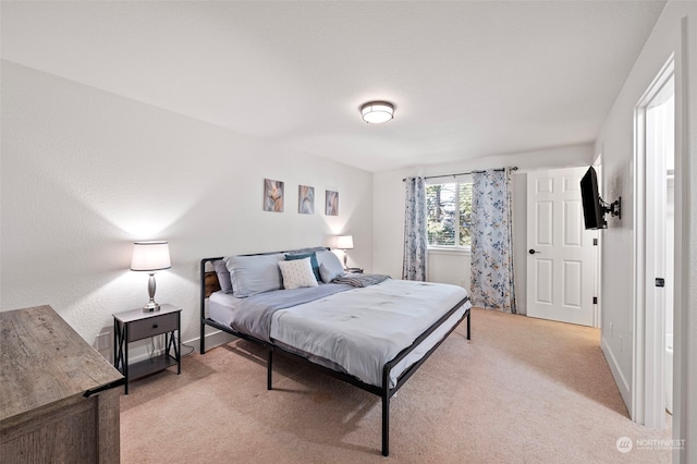 bedroom featuring light colored carpet