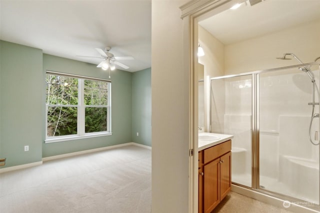 bathroom featuring vanity, ceiling fan, and walk in shower