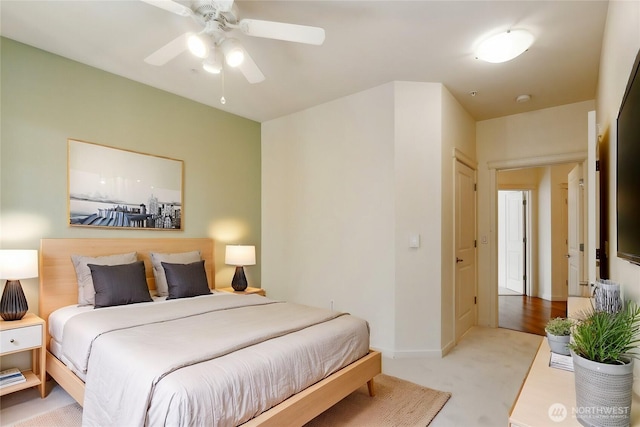 bedroom with ceiling fan and light carpet