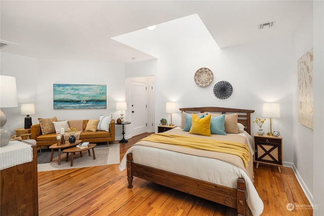 bedroom with hardwood / wood-style flooring