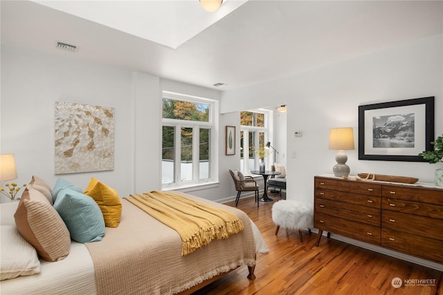 bedroom with hardwood / wood-style flooring