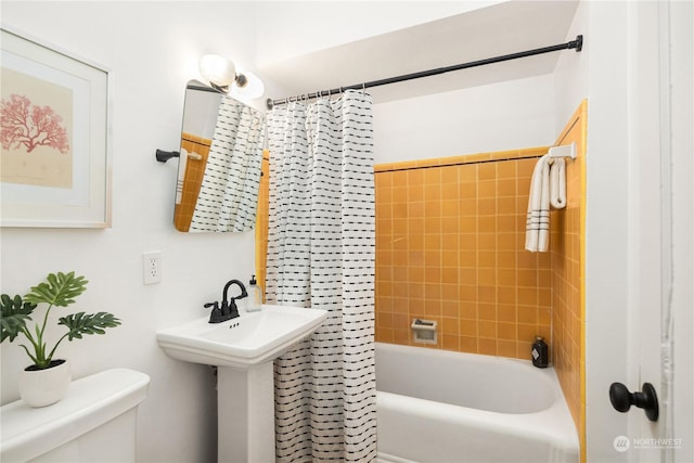 bathroom featuring shower / bath combo and toilet