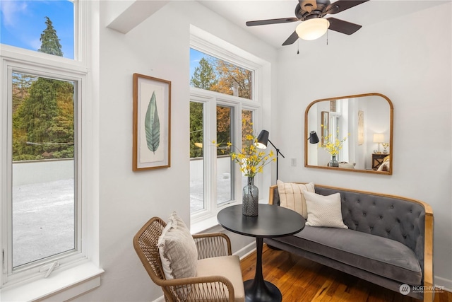 sitting room with wood-type flooring and ceiling fan