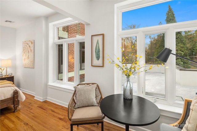 sitting room with plenty of natural light and light hardwood / wood-style flooring