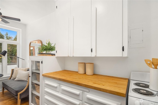 interior space featuring white cabinetry, electric stove, and ceiling fan