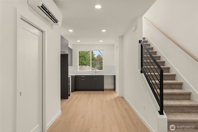 9221D 14th Ave NW, Seattle, WA 98117 - hall featuring a wall unit AC, light wood-type flooring, stairway, and recessed lighting