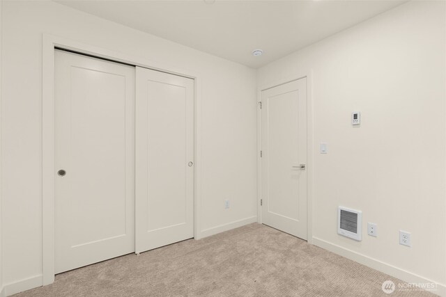9221D 14th Ave NW, Seattle, WA 98117 - unfurnished bedroom with light colored carpet and a closet