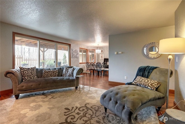 living room featuring wood-type flooring and a textured ceiling