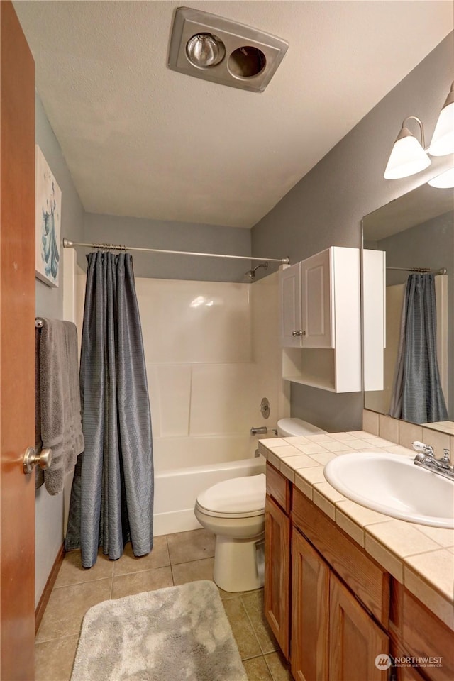 full bathroom with vanity, toilet, shower / bath combo, tile patterned floors, and a textured ceiling