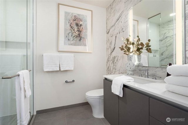 bathroom with toilet, tile walls, vanity, tile patterned flooring, and decorative backsplash